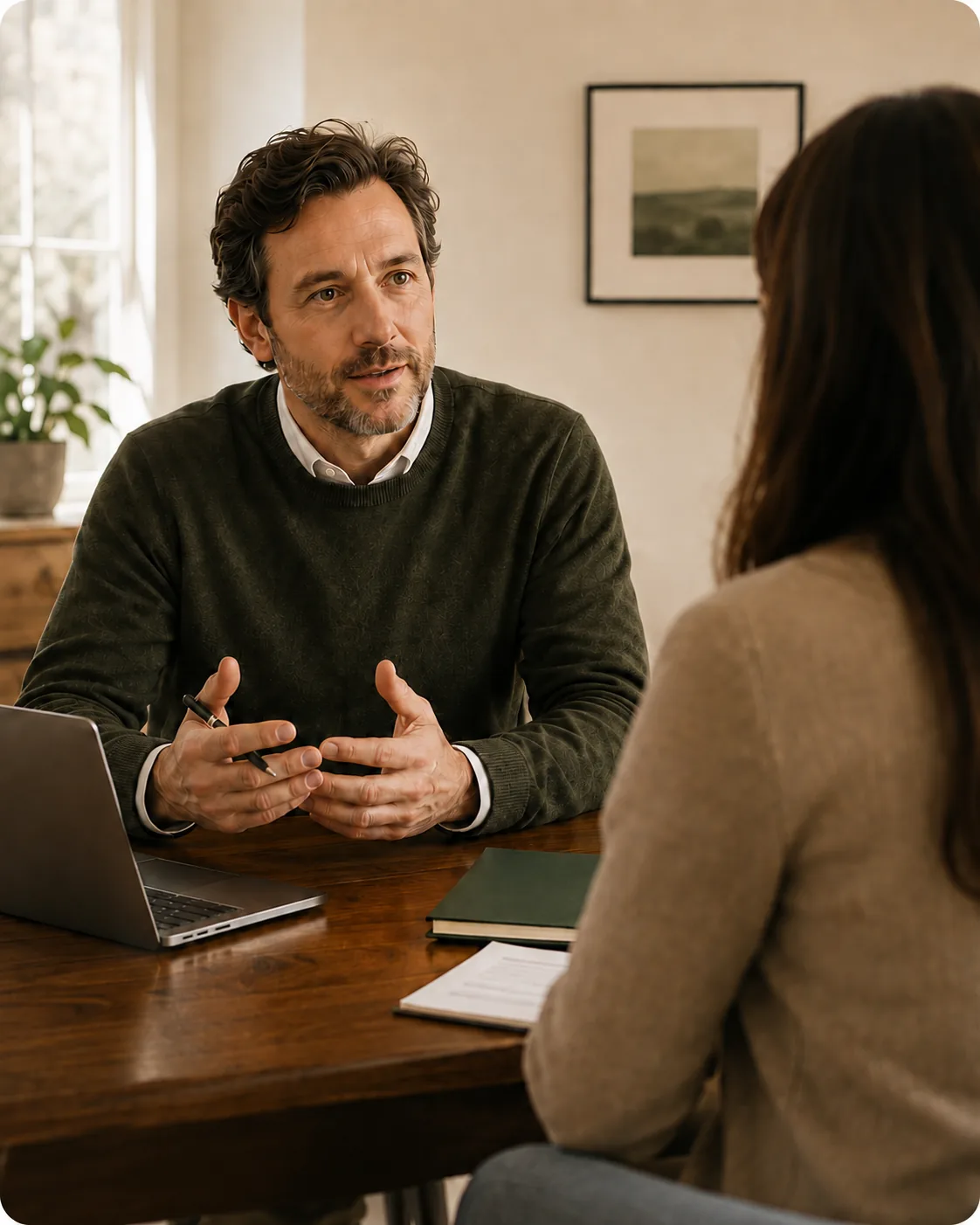 An attorney talking with a client across a desk in a small law office